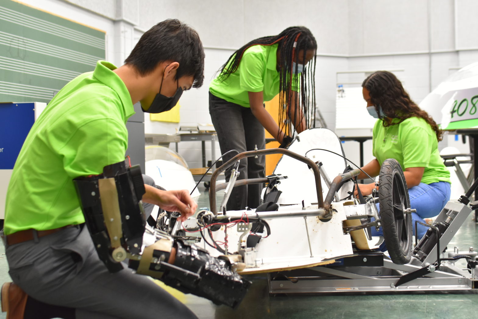 CAST STEM students work on an electric car