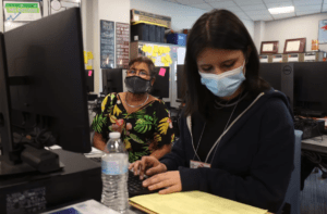 Cast Tech ninth-grader Melina Ornelas helps Elena Perez prepare her taxes